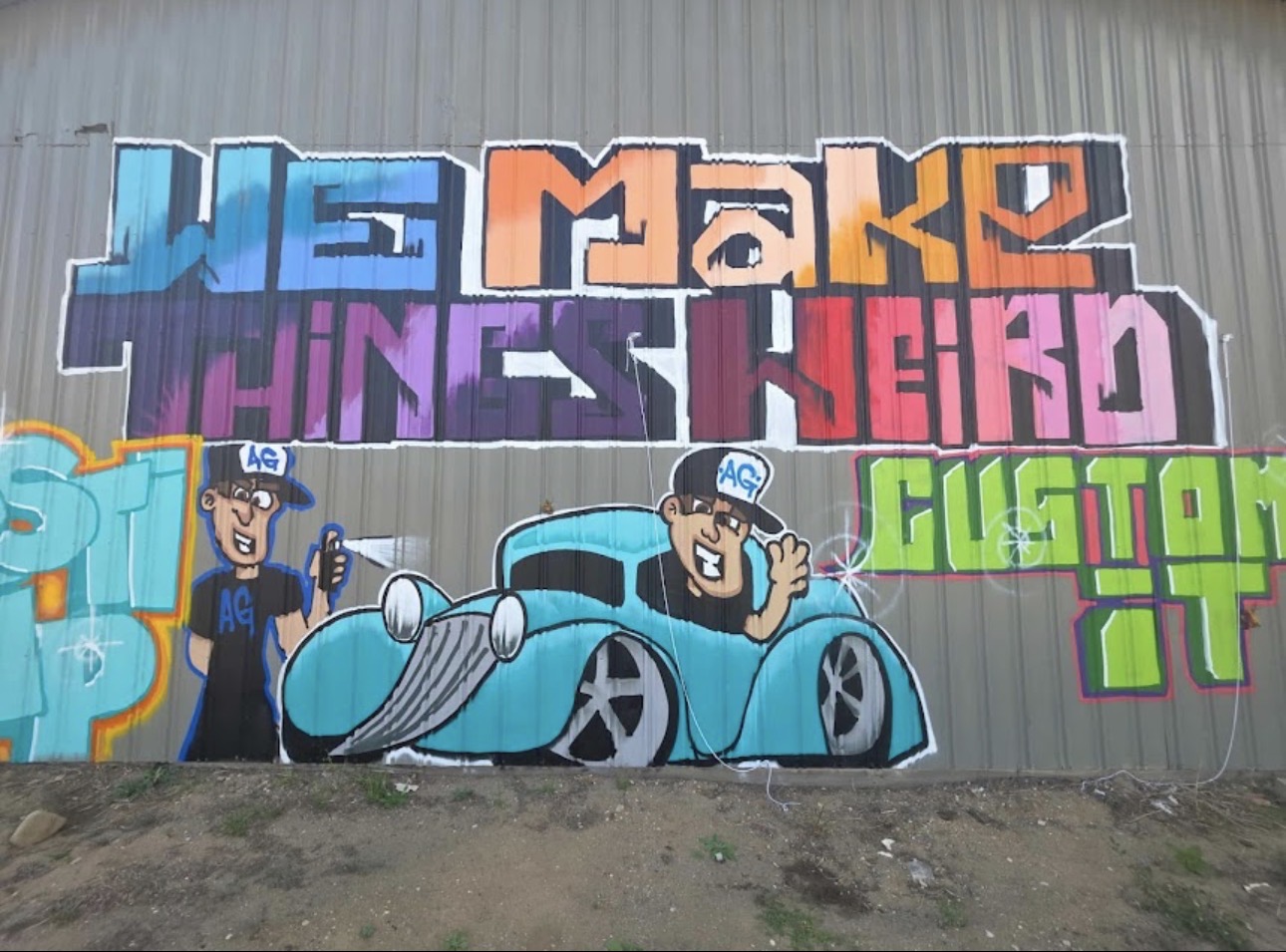 Hand-painted Auto Guys mural: 'We Make Things Weird' with cartoon crew and custom car
